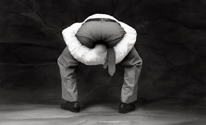 Iconic old meme image of a guy with his head up his own ass.