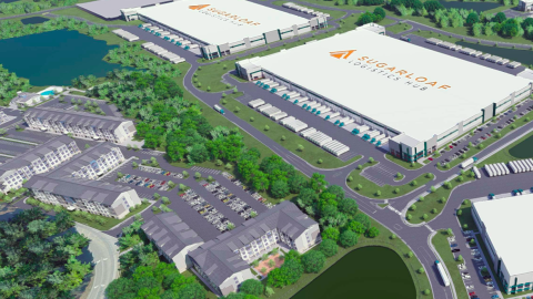 An image of a large industrial development site in suburban Atlanta with many apartments and surface parking areas and trees near lakes.