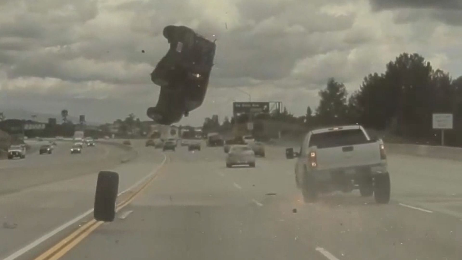 SUV launched the the air from hitting a tire