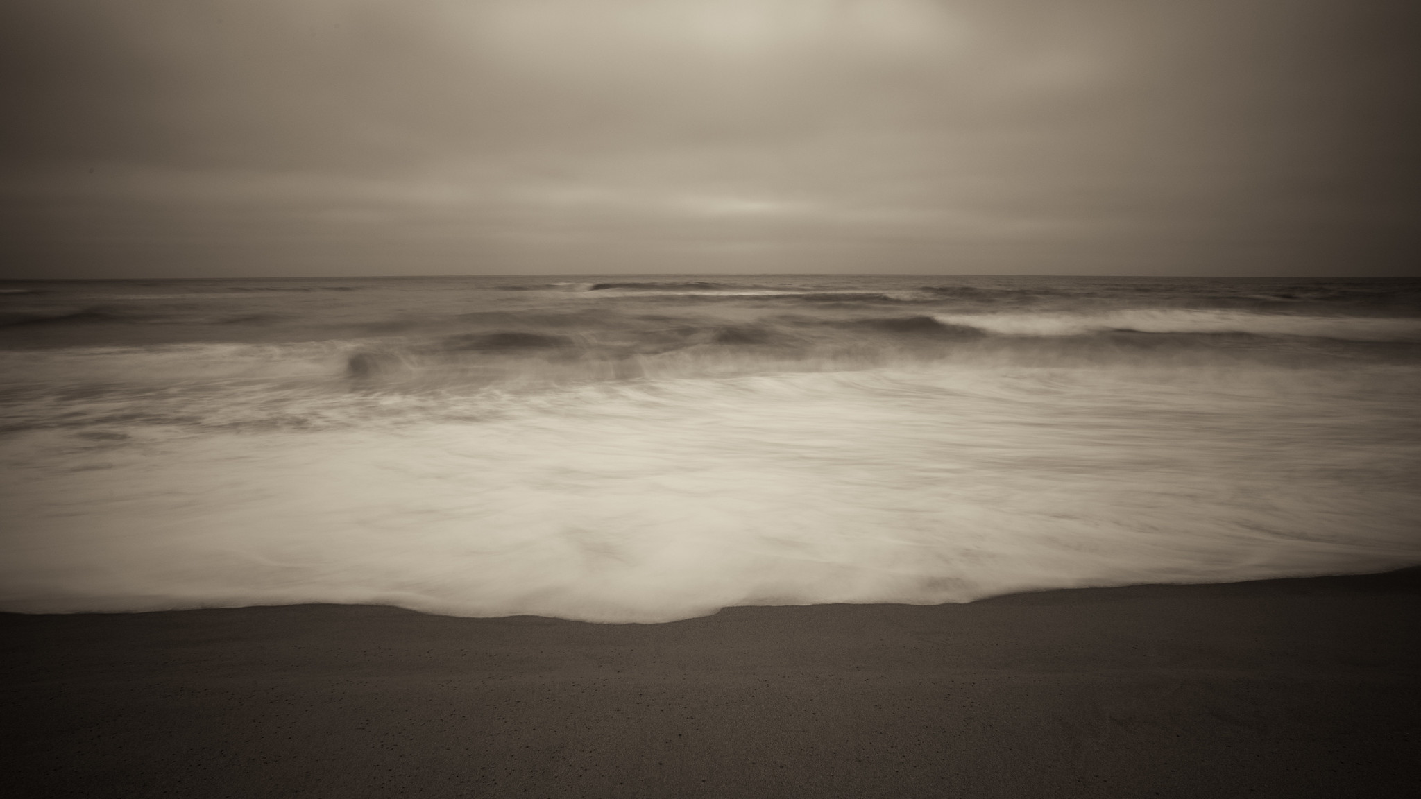 Pacific Ocean, viewed from a beach, on an overcast day.