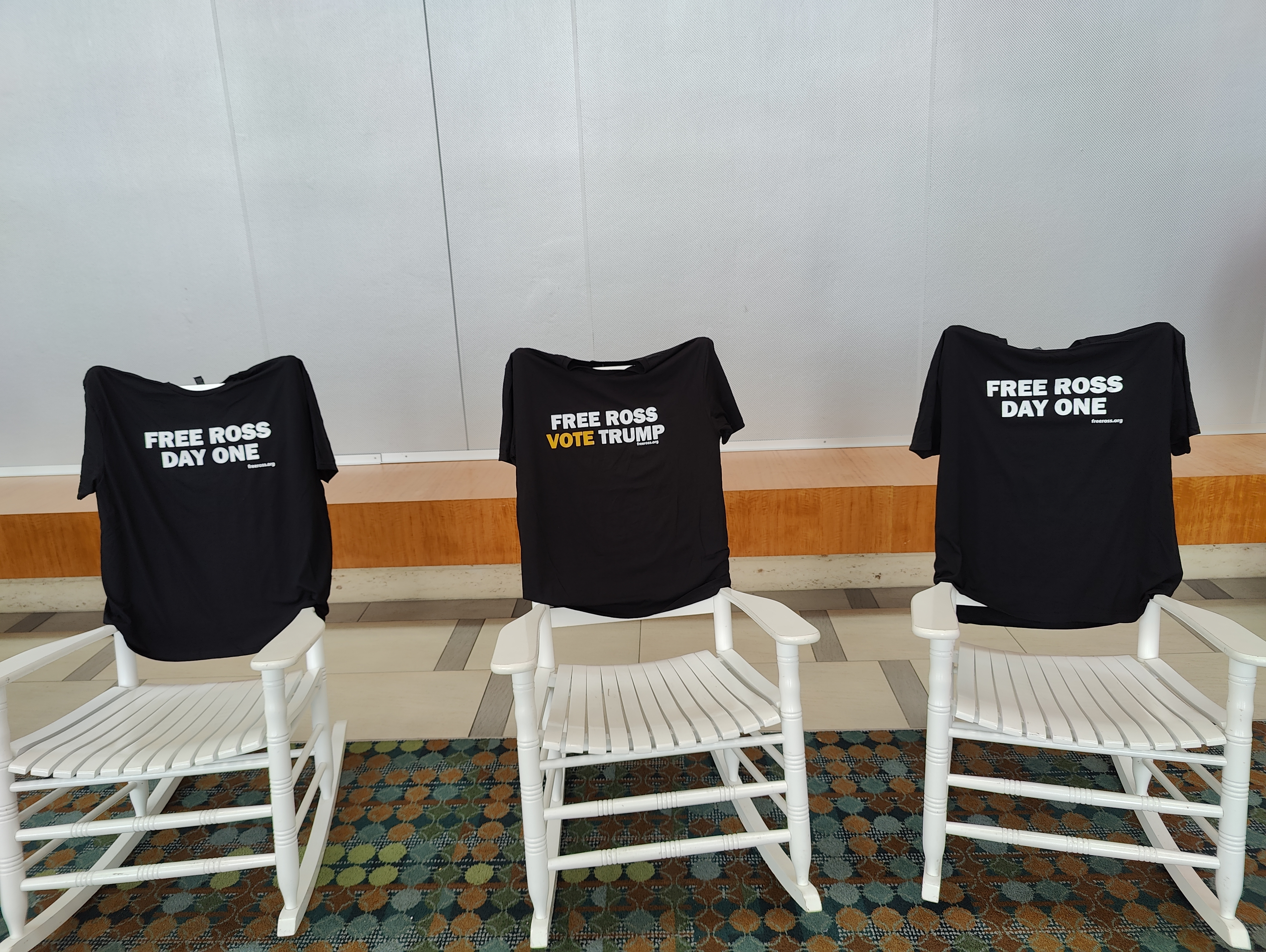 3 rocking chairs holding shirts that say "Free Ross" and "Free Ross; Vote Trump"