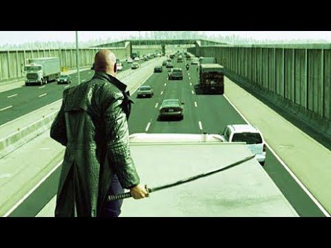 A shot from the Matrix of Morpheus staying at the roof of the bed of a truck driving on the highway