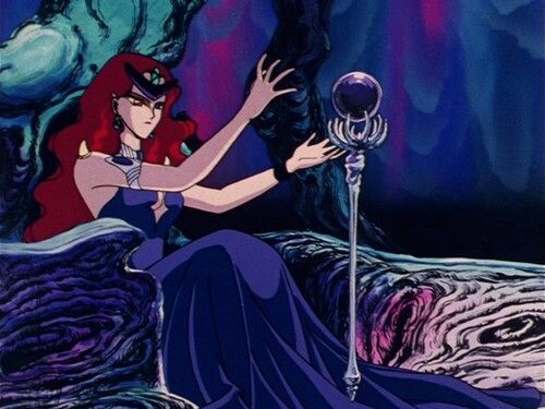 Queen Beryl, a villain from Sailor Moon. A tall person with crimson hair a black diadem and a deep purple dress. They're sitting on a throne and holding a black scepter. I'm saying "they/them" because I'm following the joke premise that they're non binary, but I'm almost sire they're supposed to be a woman. They have breasts and are called "queen".