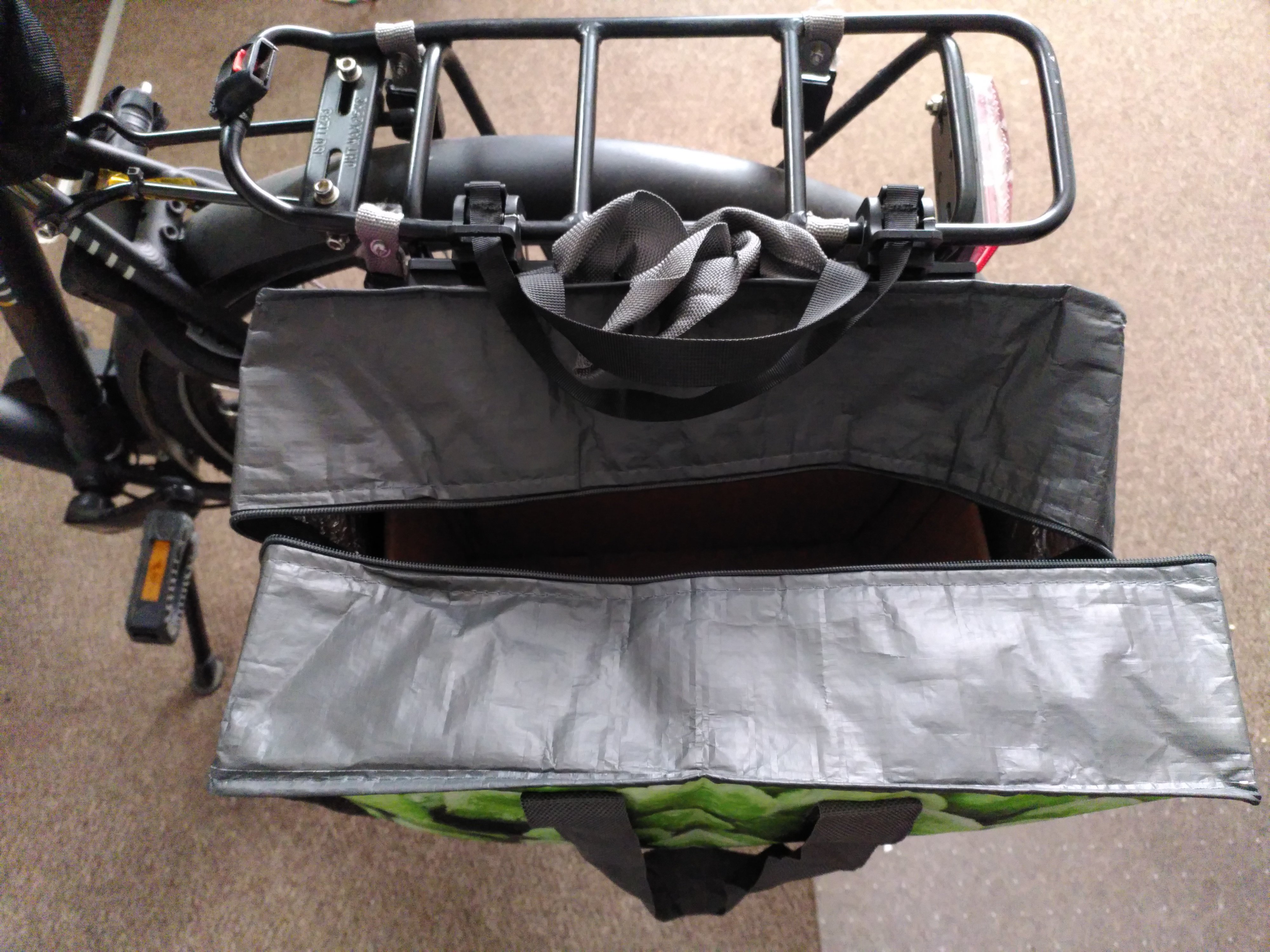 Picture of shopping bag attached to bicycle with a retrofitted pannier rack