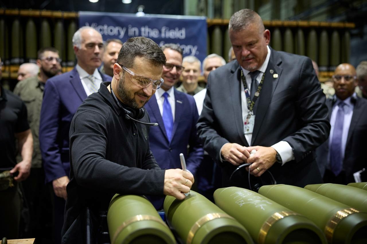 President Zelensky signing a 155 munition at a Pennsylvania munitions production plant