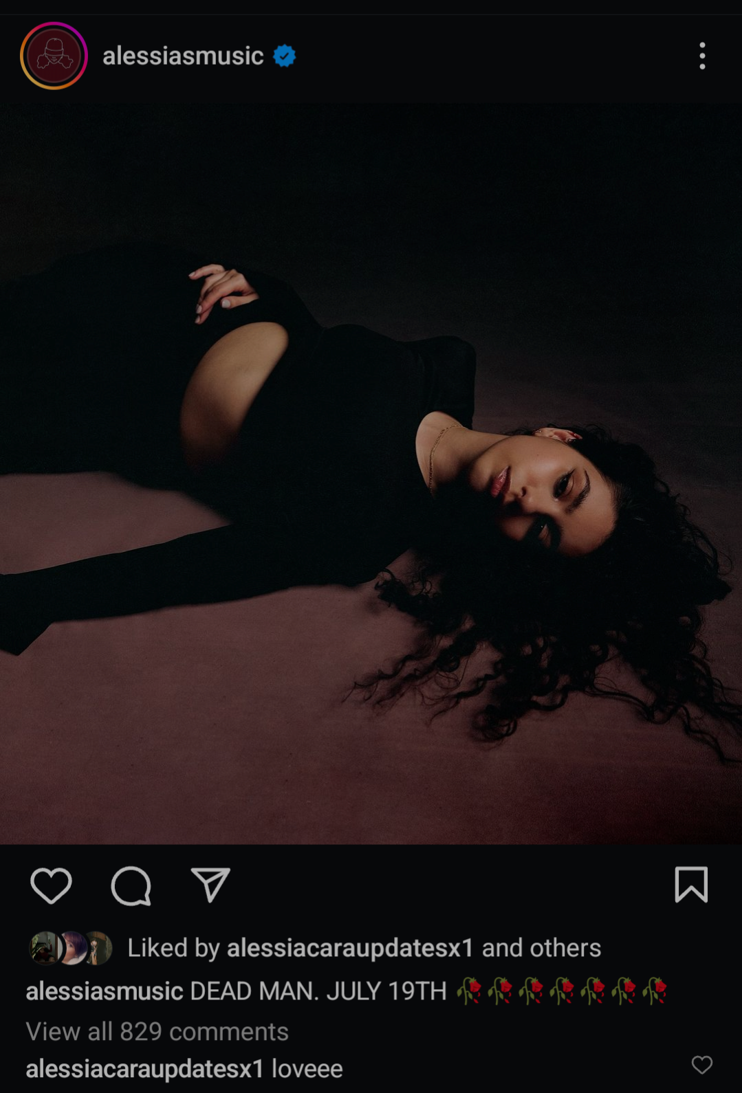 Alessia Cara Instagram post with the message Dead Man 19 July.

The photo depicts Alessia, in a black top, laying down on a reddish-brown rug.