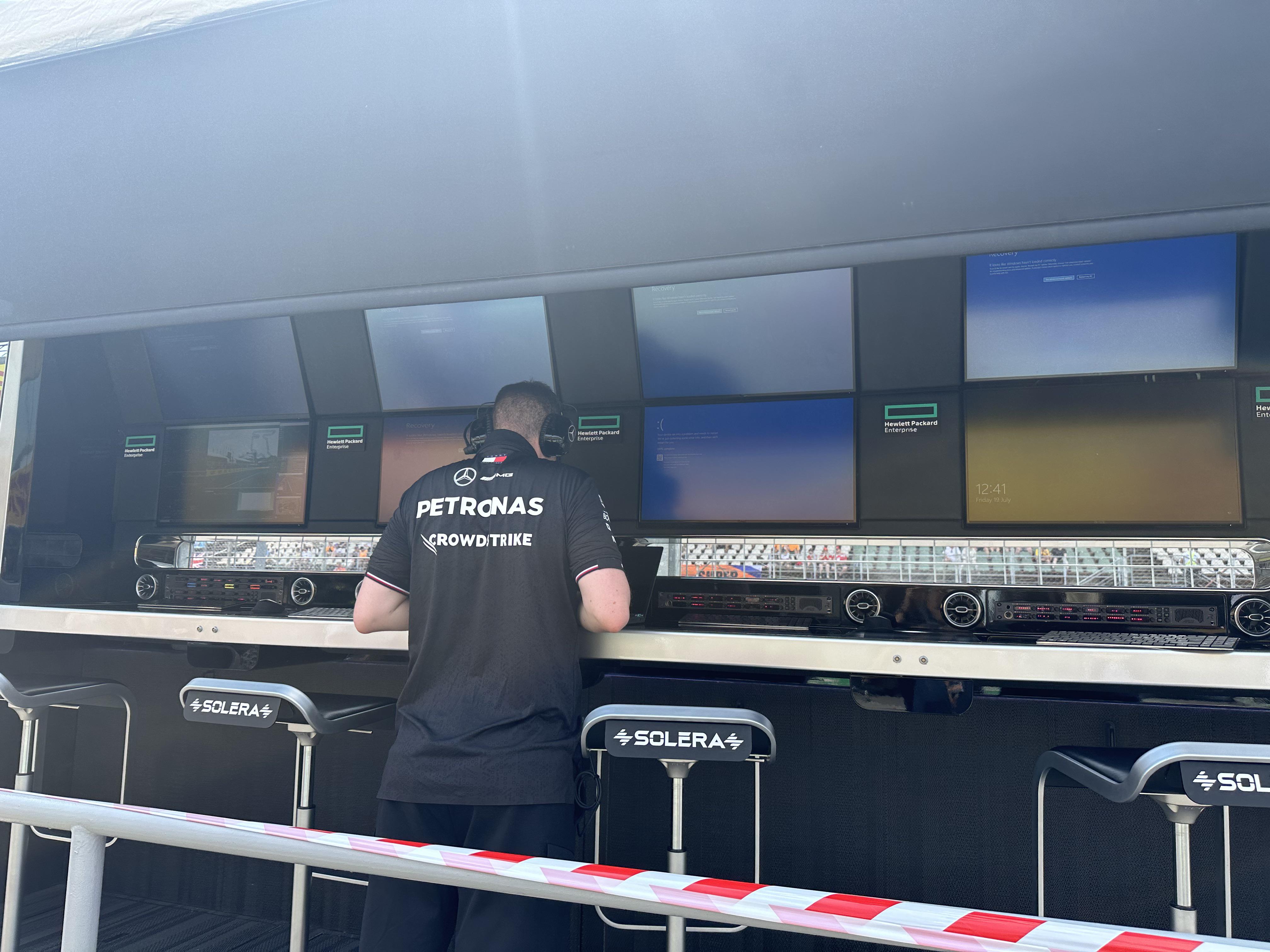 Mercedes F1 pit wall with blue screens of death