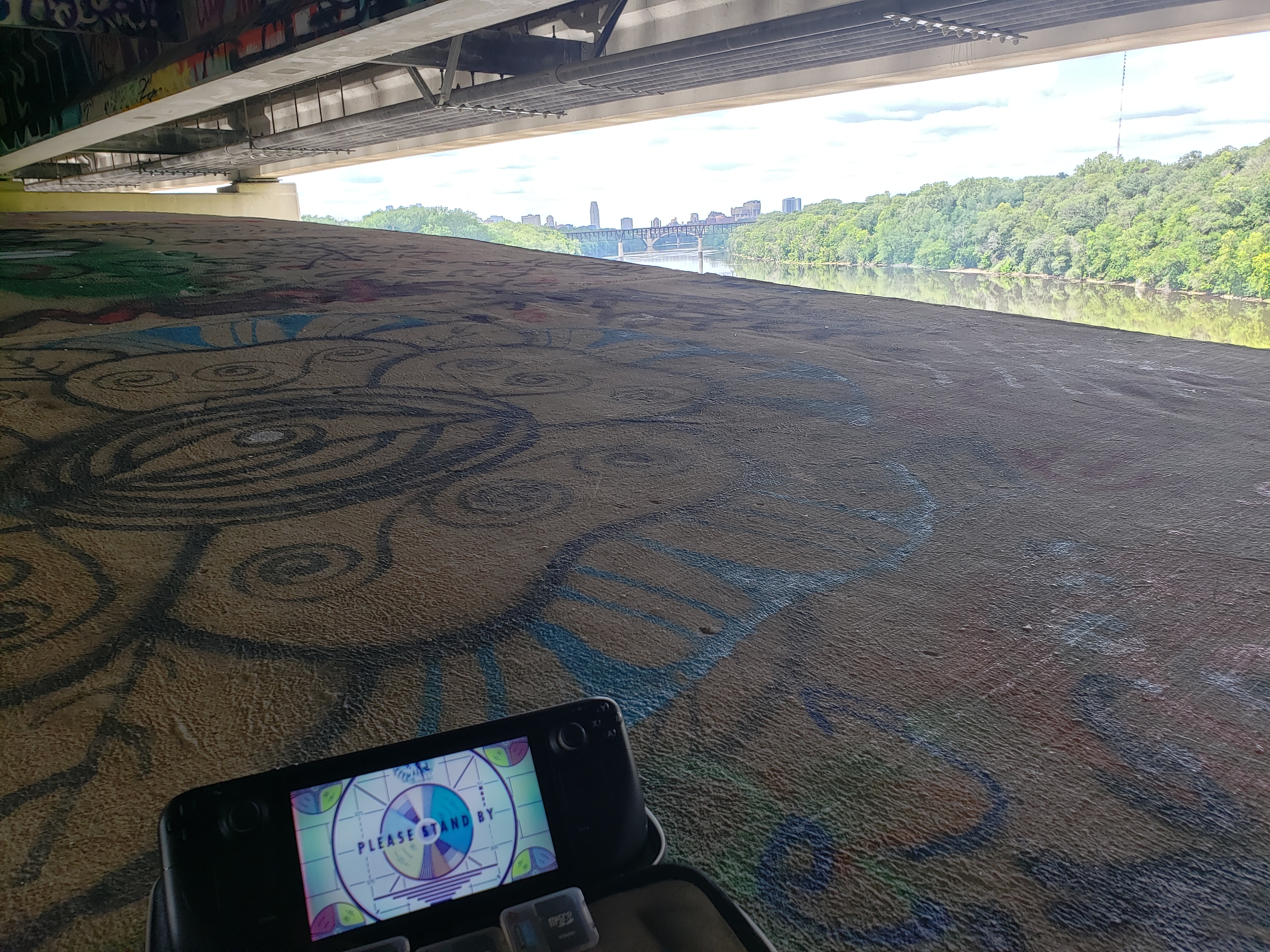 A picture of a steam deck along a river overlooking the cities