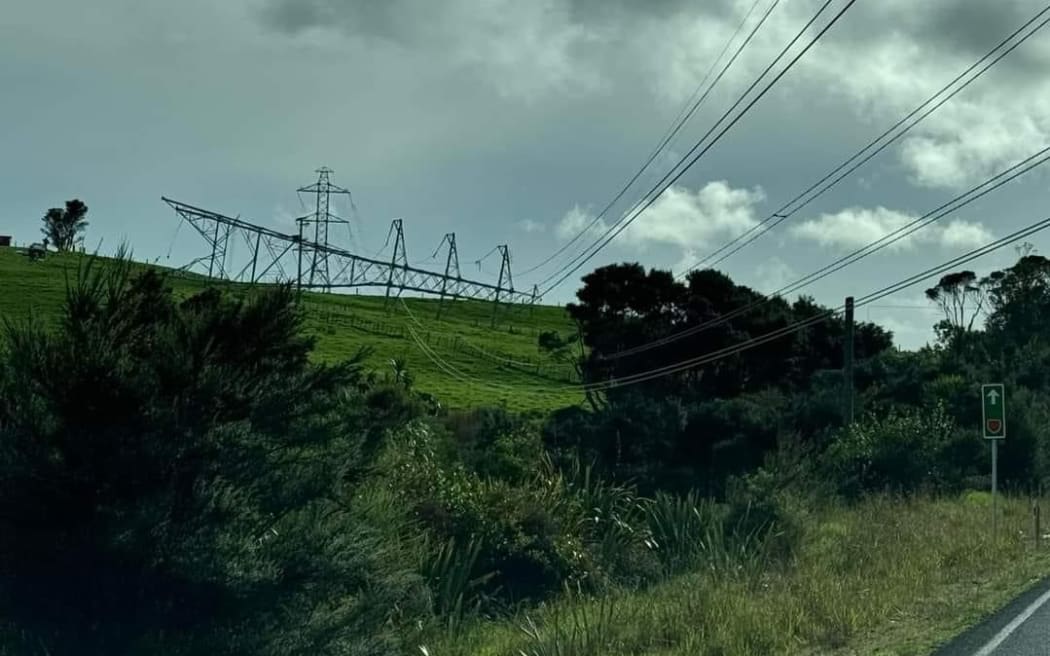 picture of fallen pylon lying on grassy hill