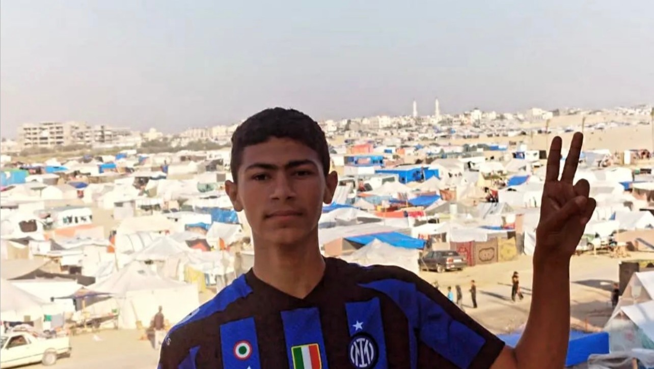 Yazan amidst fellow displaced peoples' tents in Rafah