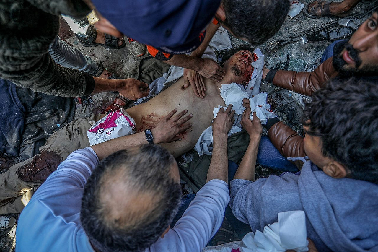 Palestinians at the site of an Israeli airstrike in Rafah, in the southern Gaza Strip, February 24, 2024. (Abed Rahim Khatib/Flash90)