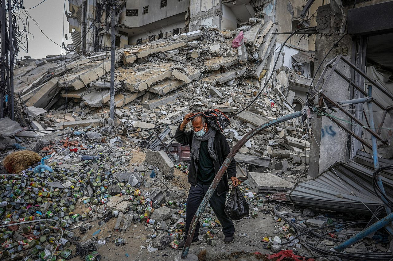 Palestinians at the site of a building destroyed by an Israeli airstrike in Rafah, in the southern Gaza Strip, March 18, 2024. (Abed Rahim Khatib/Flash90)