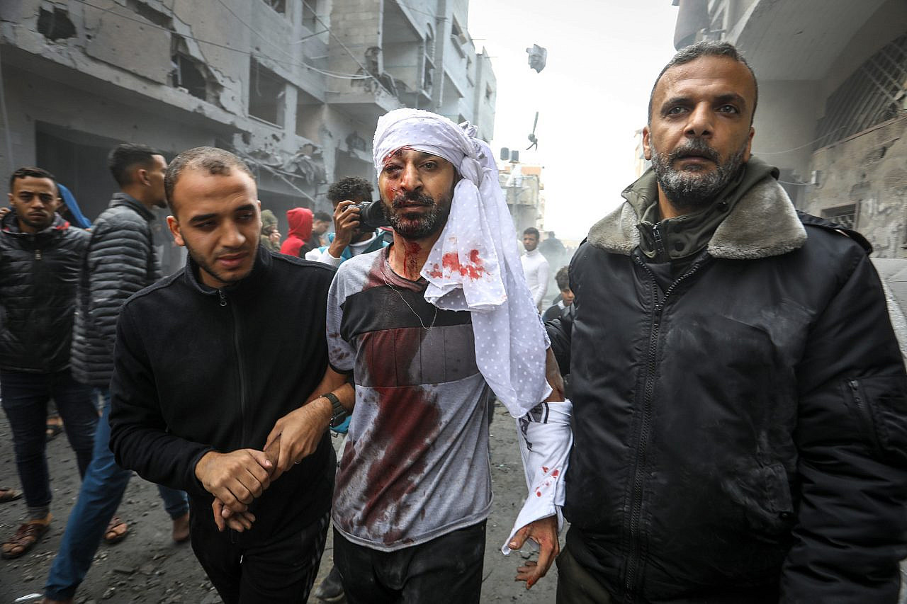 Palestinians emerge from the rubble of houses destroyed in Israeli airstrikes in the city of Rafah, southern Gaza Strip, November 20, 2023. (Abed Rahim Khatib/Flash90)