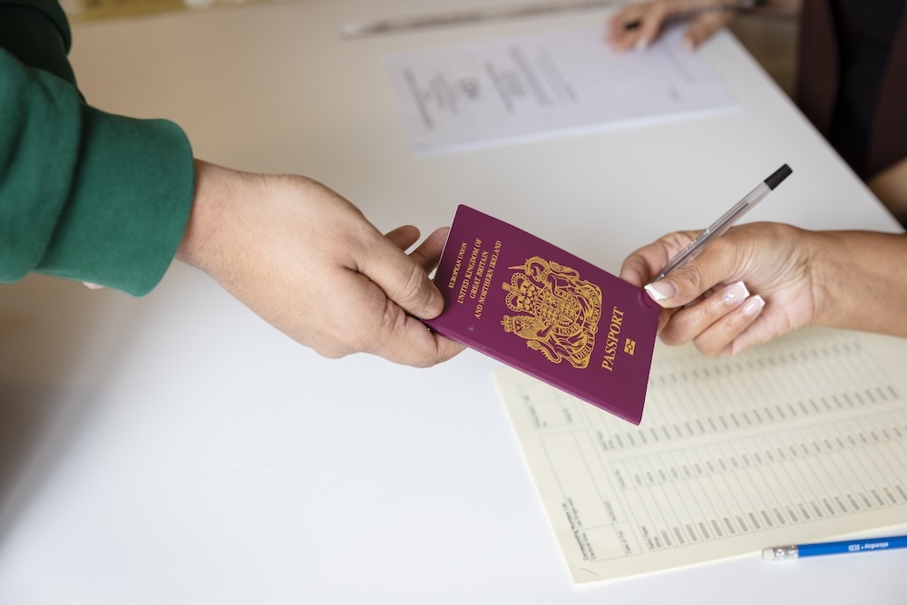 A voter showing their passport at a polling station.